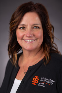 Staff Member headshot, brunette, smile, ISU Cardigan