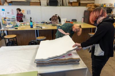 Students work on paper art projects