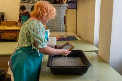 Students work on paper art projects