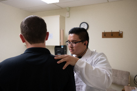 Student working in the campus doctors office.