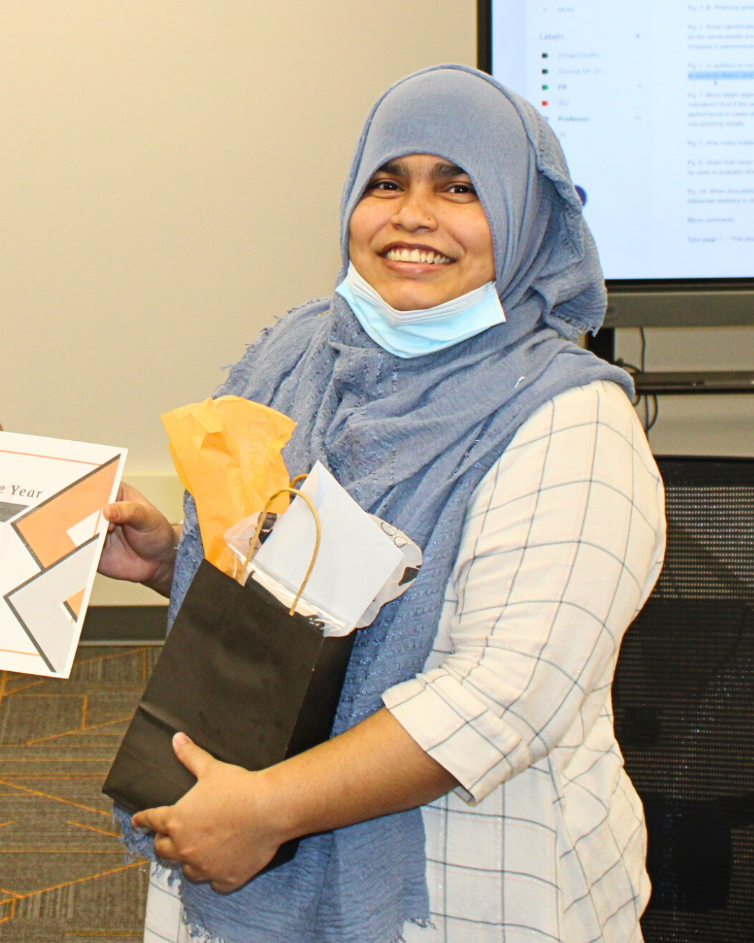 Arifa Champa holding the second runner up award for Student Employee of the Year.