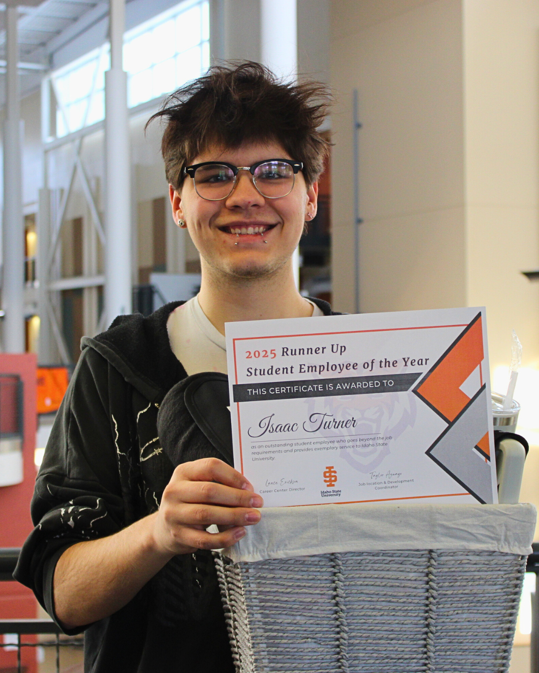 Isaac Turner holding the third runner up award for Student Employee of the Year.