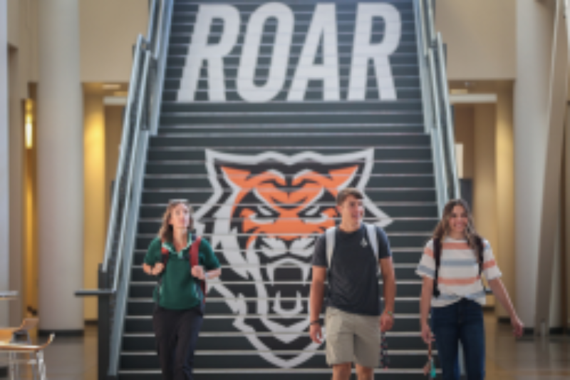 Three students walking through the Rendezvous building on the ISU campus.