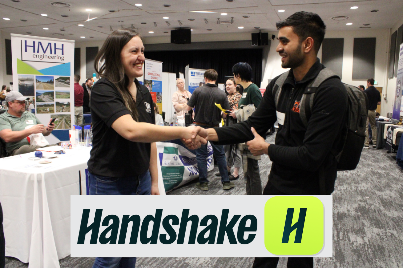 Student shaking hand with an employer at the career fair