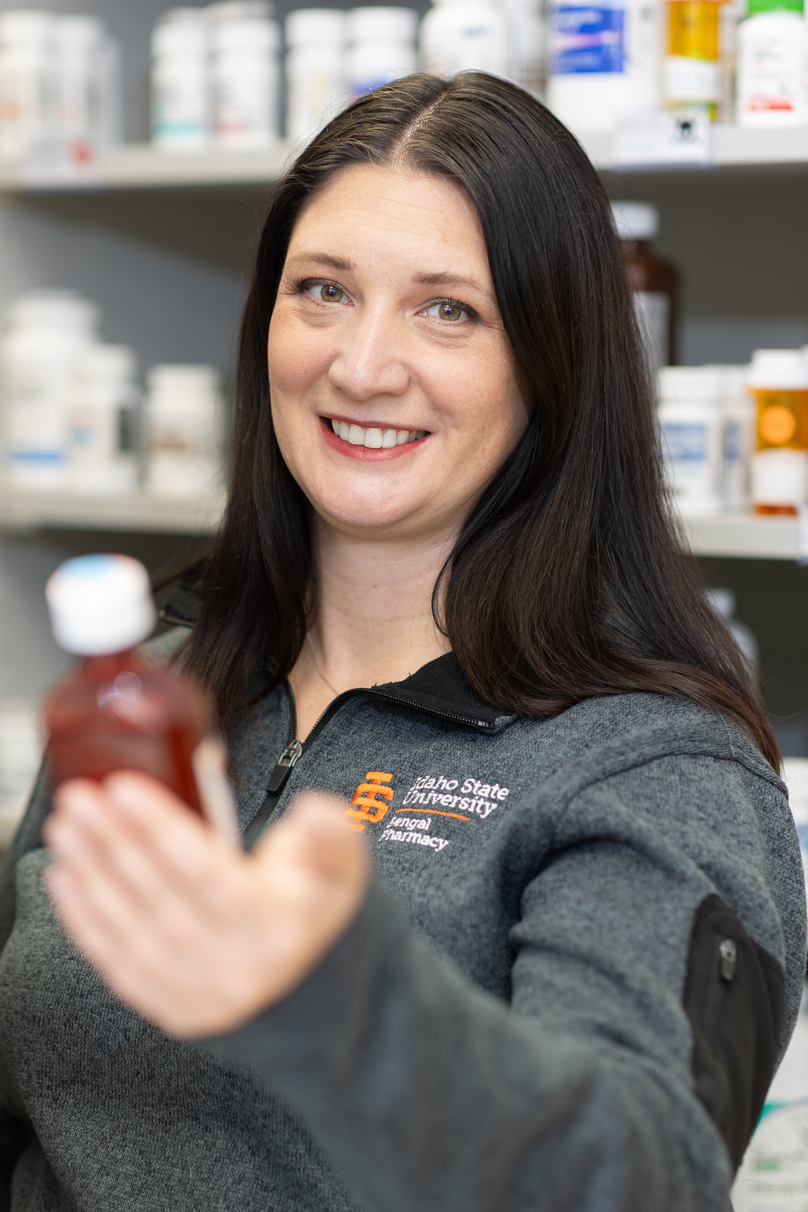Pharmacist holding liquid bottle