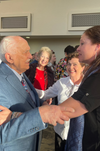 Roy Miller and Tara Young clasp arms