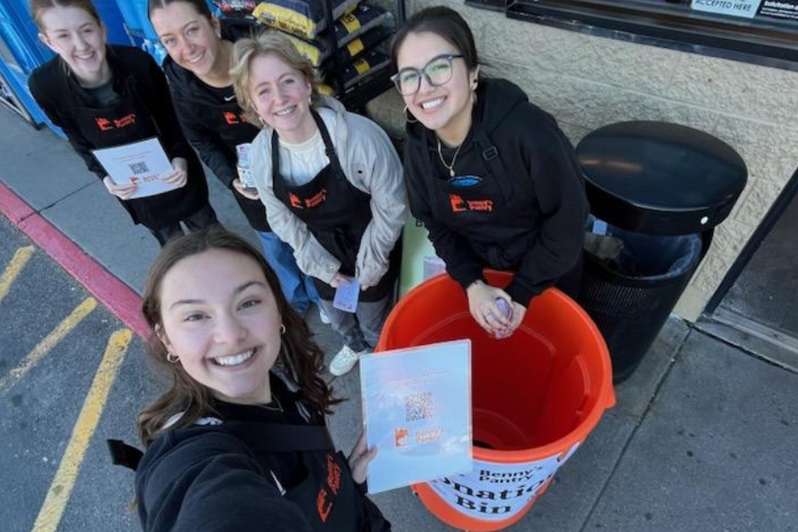 Five student volunteers helping with a donation drive