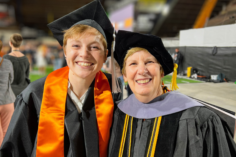 Grad student and professor in regalia