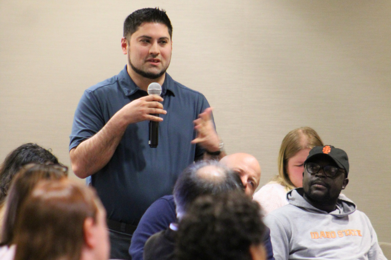 An audience member speaks on a microphone