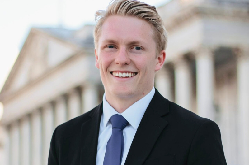 Headshot of Eric Morris in front of White House