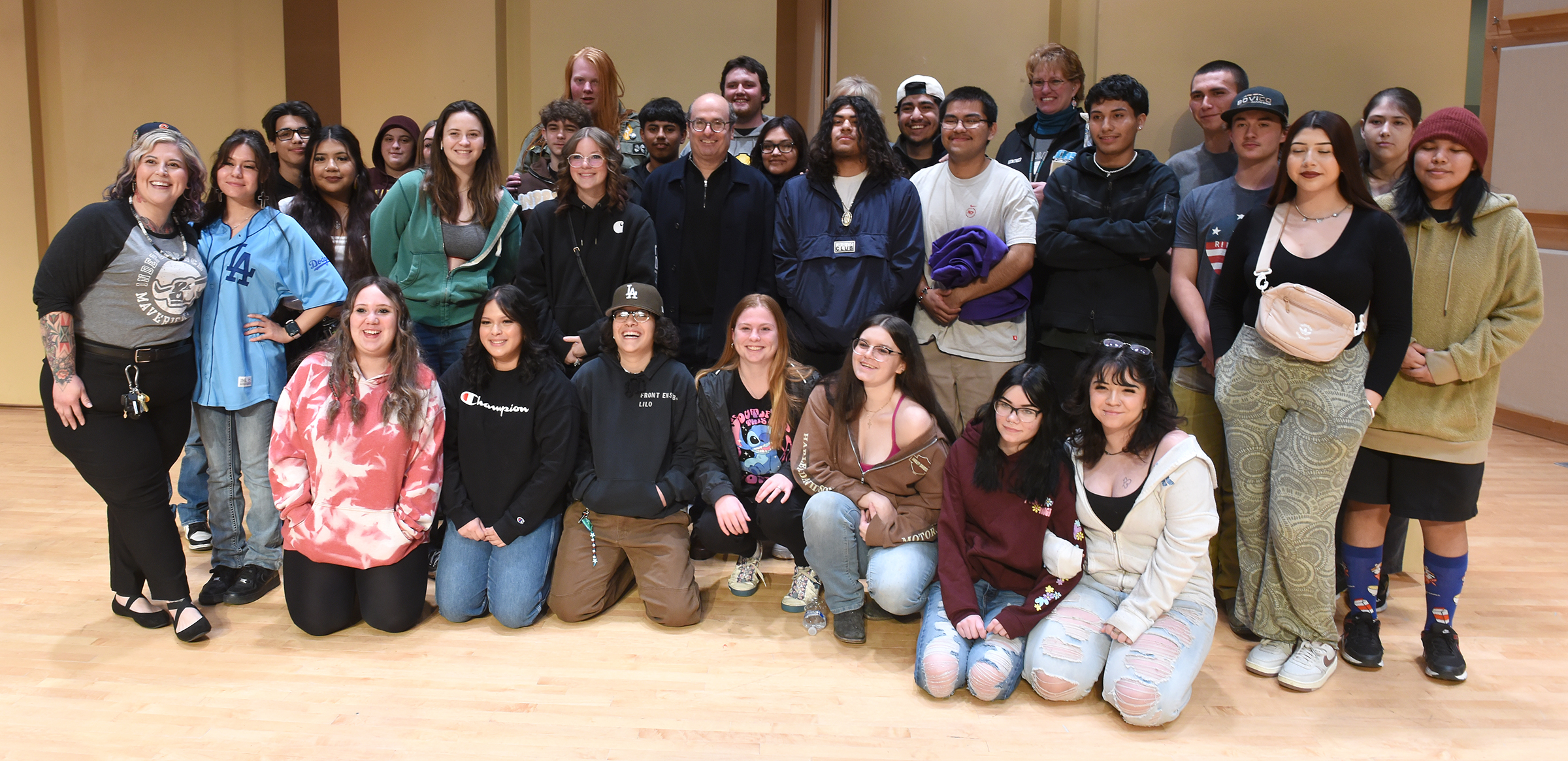 David Grann stands in the midst of students with Independence High School