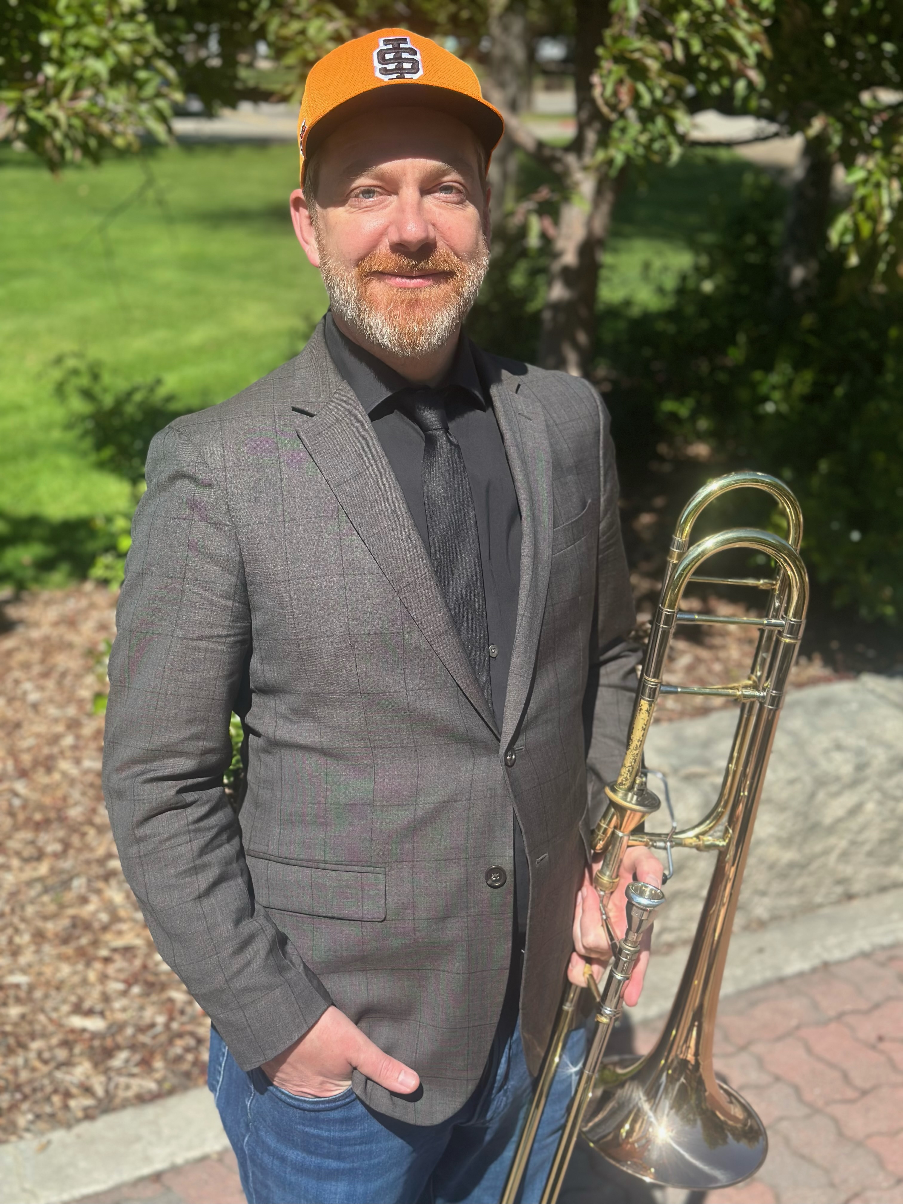 Luke Strother with an ISU hat and trombone