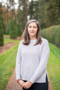 Headshot of Marin standing outside with backshot of trees