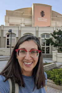 Selfie of Marin standing in front of the Stephen's Performing Arts Center in summer.