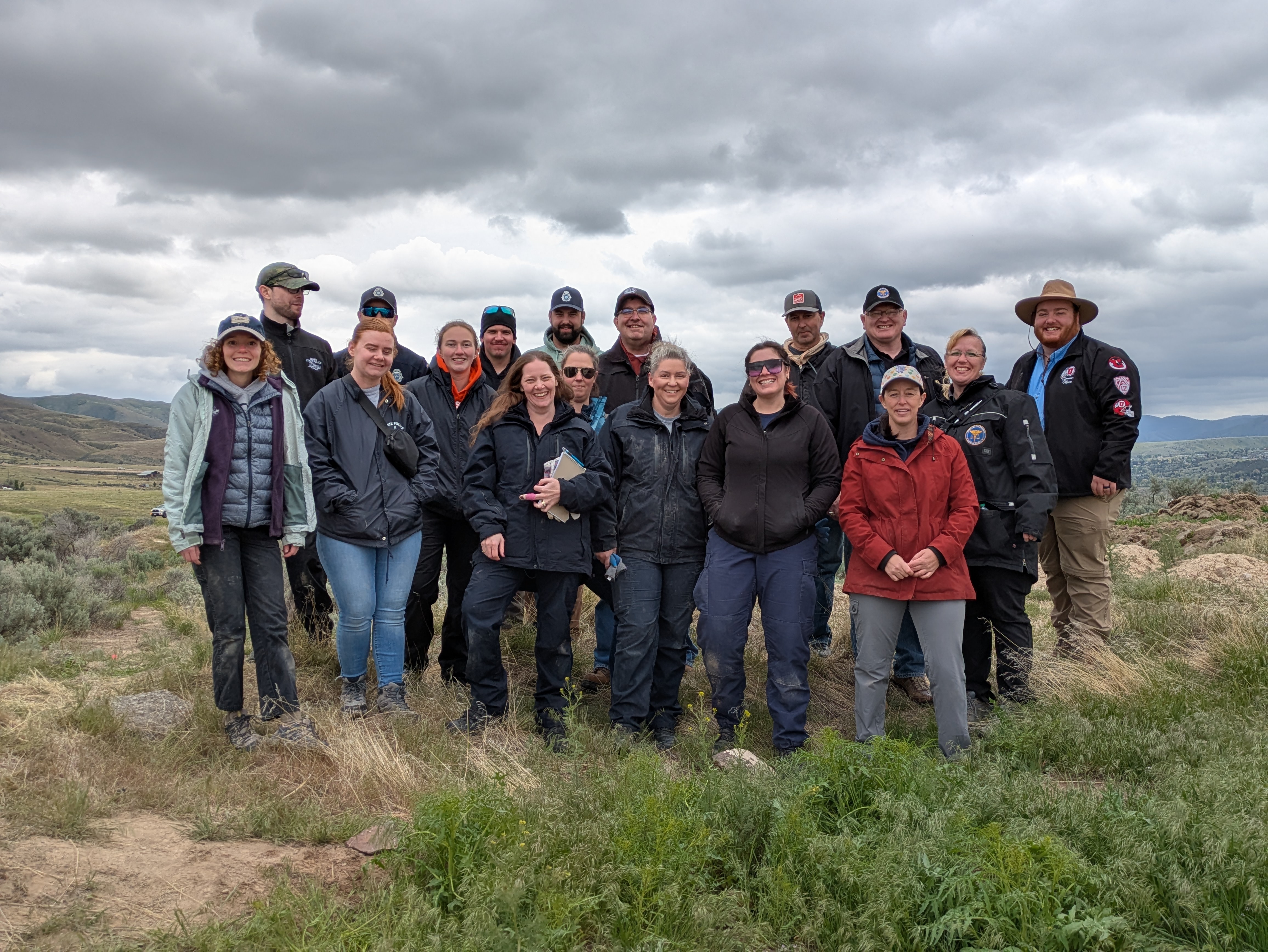 A group of students and instructors gathered together for the mock burial