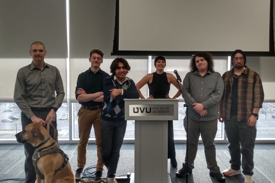 Philosophy Club students stand in a line next to a podium