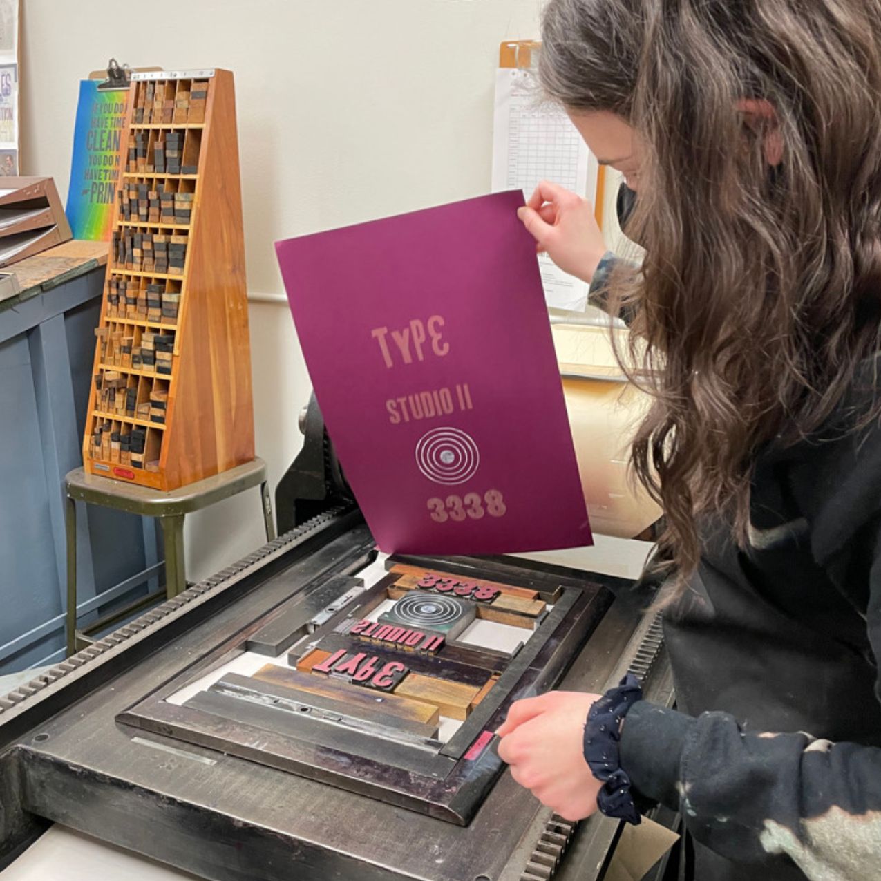 A student works a printing press