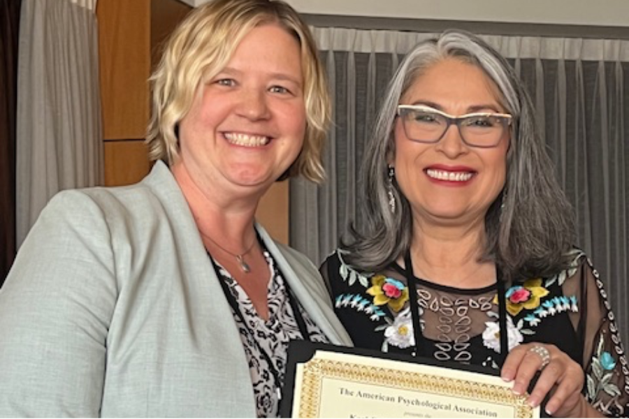 Westerhaus receives her award certificate from an APA representative