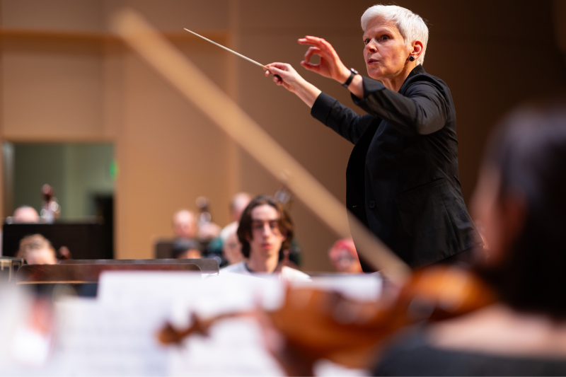 Director Flanders conducts with baton