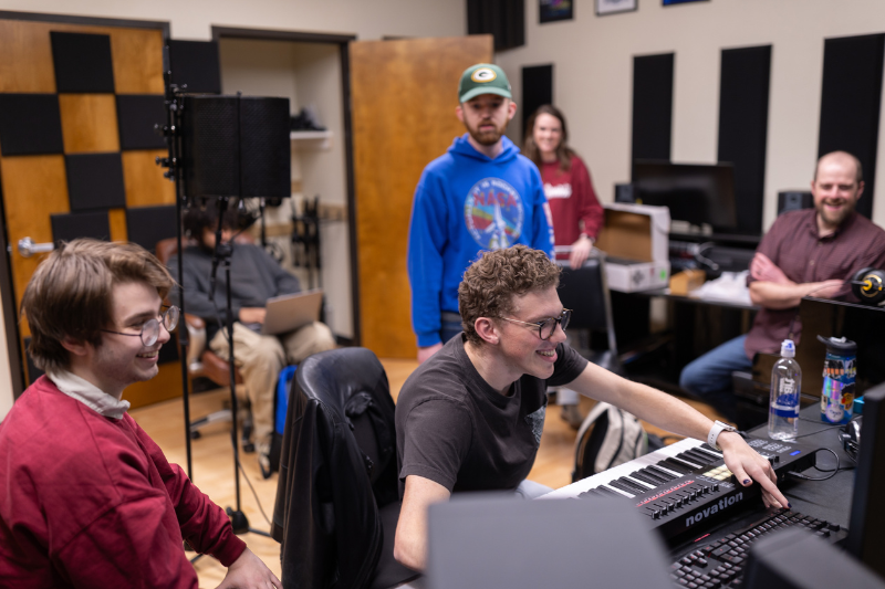 students and faculty work together in the recording studio