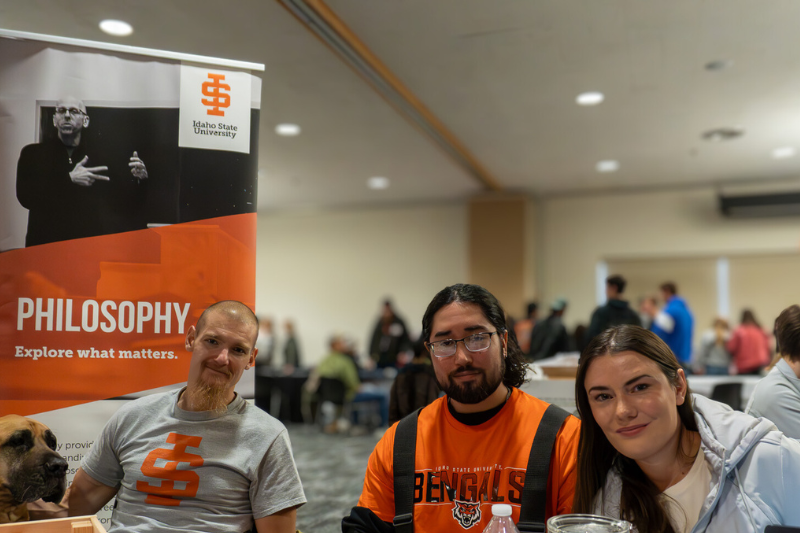 three students sit at a table