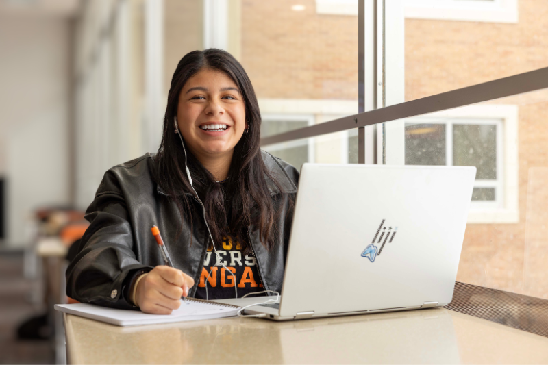 a student works on her laptop