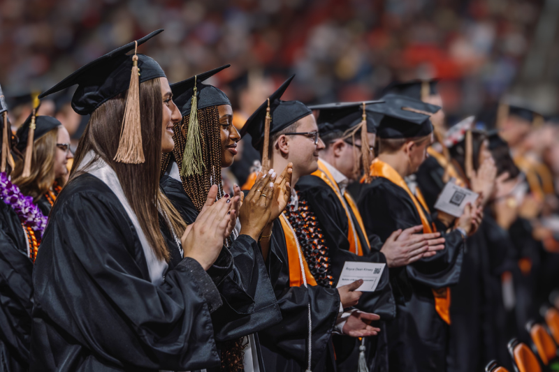 Students at commencement ceremony are clapping