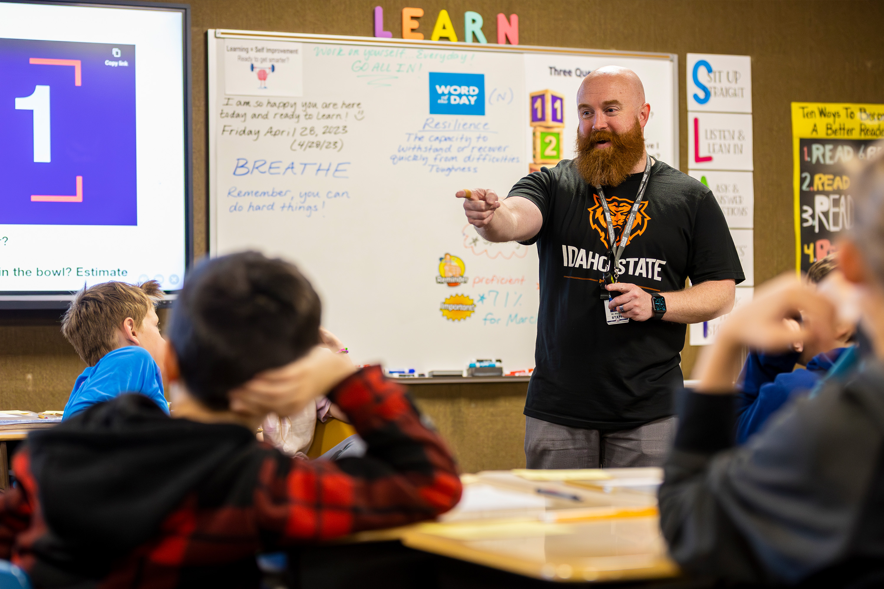 An alum teacher teaching his elementary school class