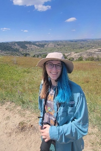 Alia Hitchcock in front of a green valley