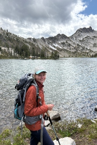 Ashley Butterworth in front of a lake with a mountain