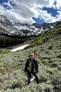 Nicole Rowse in a field with a mountain in the background