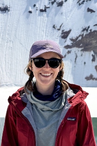 Tess Oldroyd-Johnson portrait in front of a snowy mountain