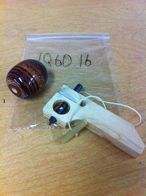 A wooden top with its ripcord