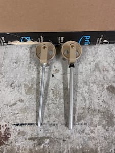 Two pulleys used for the Atwood's Machine sitting on a table