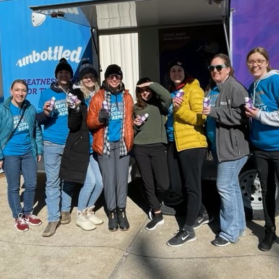 students standing in front of a dairy west milk truck
