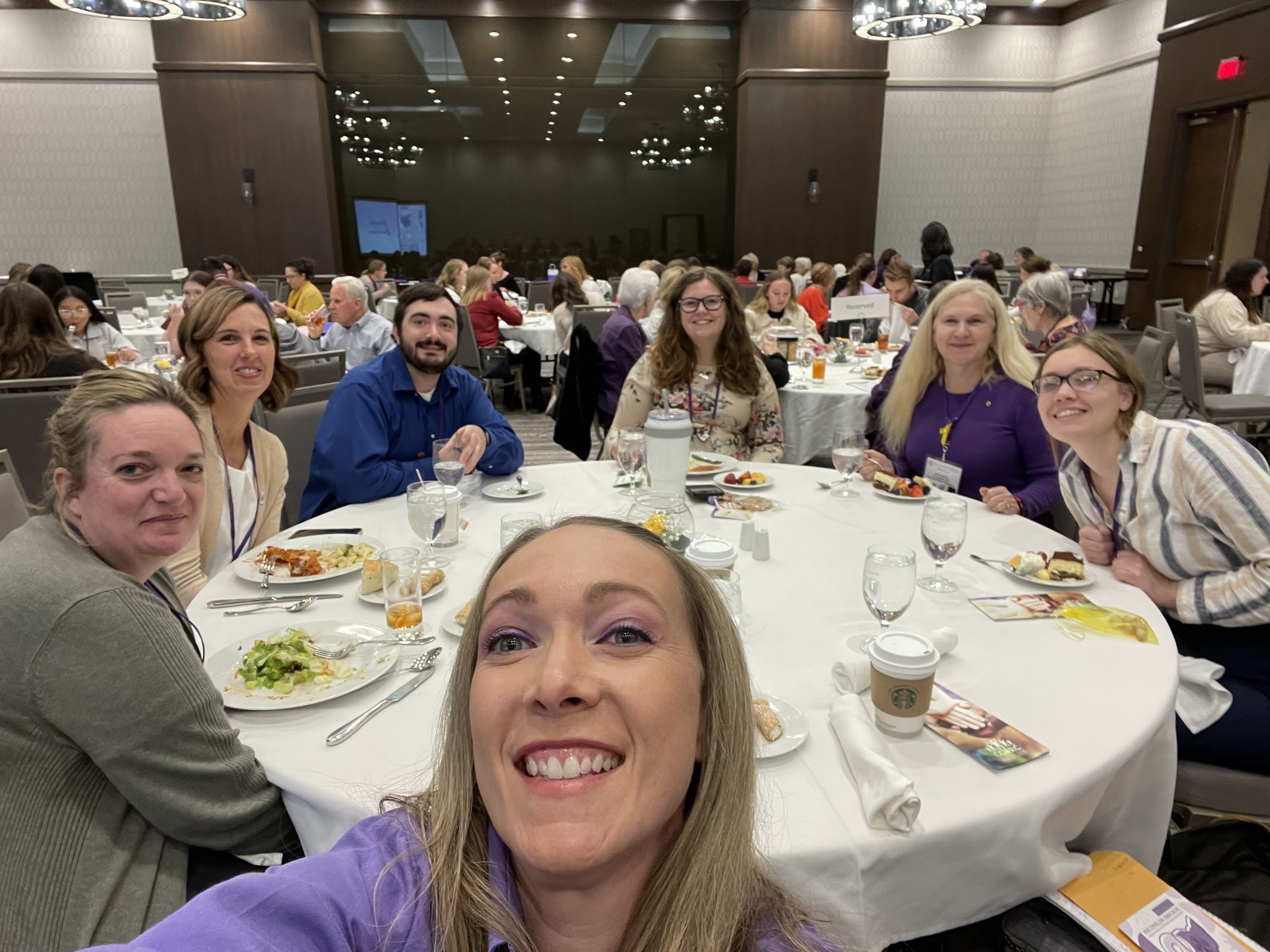 Phi Upsilon Omicron members sitting at a table at an annual conference