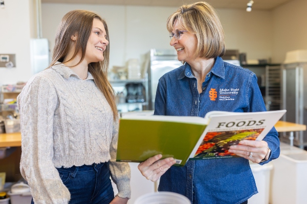 Professor educating a student on terms in a nutrition textbook