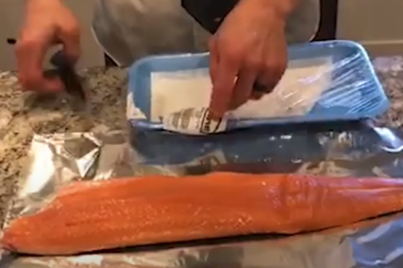 Sports dietitian, Natalie Christensen's husband preparing a salom filet