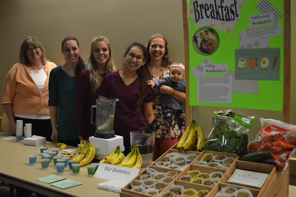 Dietetics Program Director with Students infront of booth. 