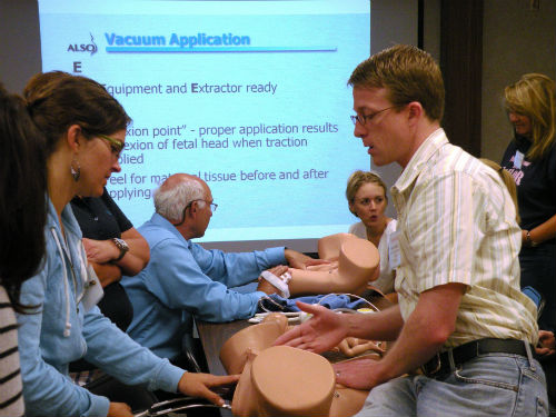 Students learning maternal life support with birth models