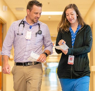 Physicians walking down hospital hallway