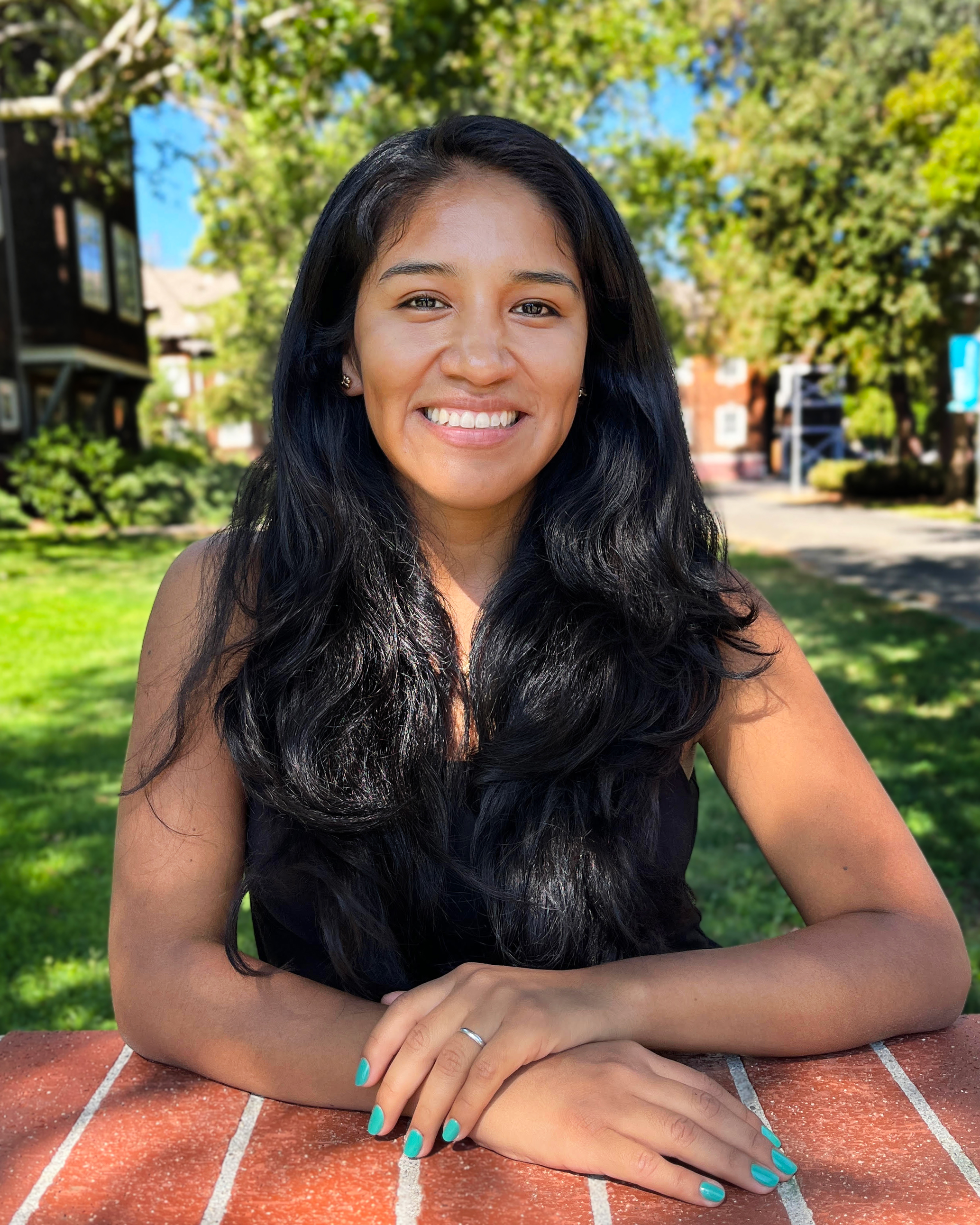 Faculty member sitting outdoors