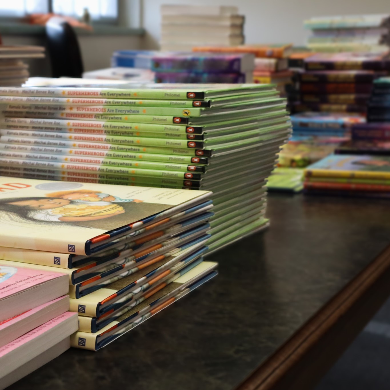 stacks of books donated for the Graduate School book drive