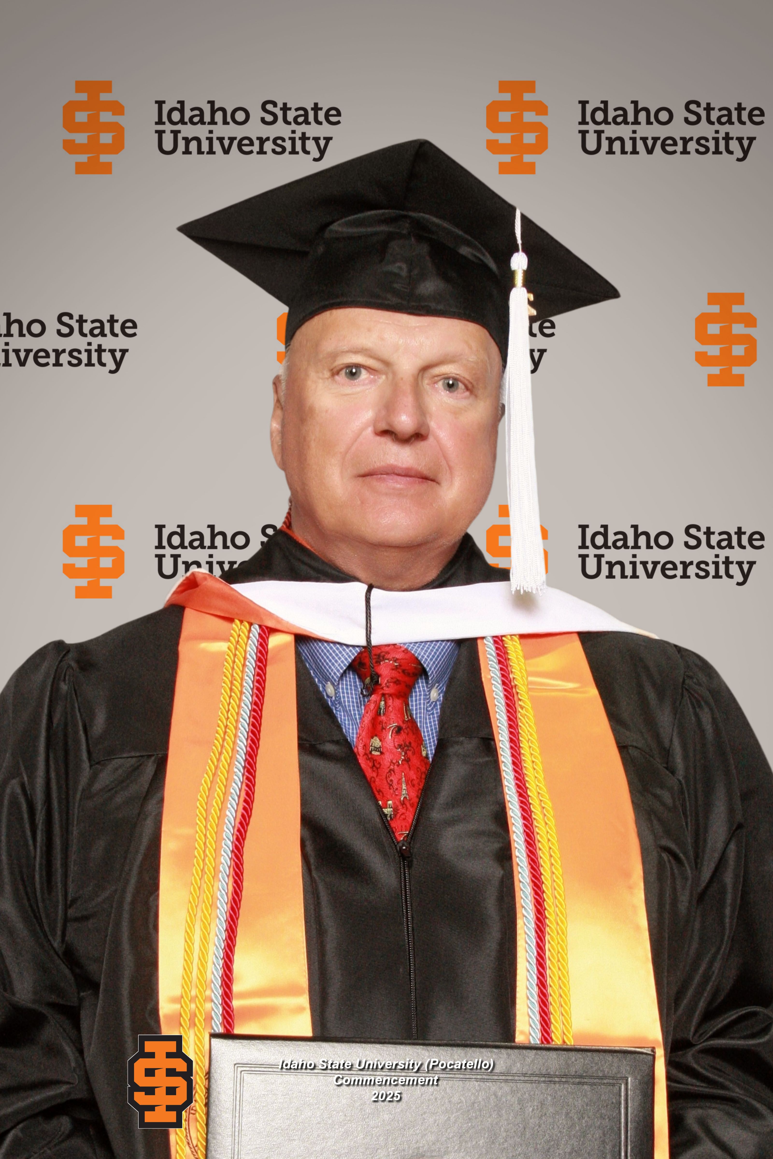 headshot of Holger Nickel posing in his formal graduation clothing