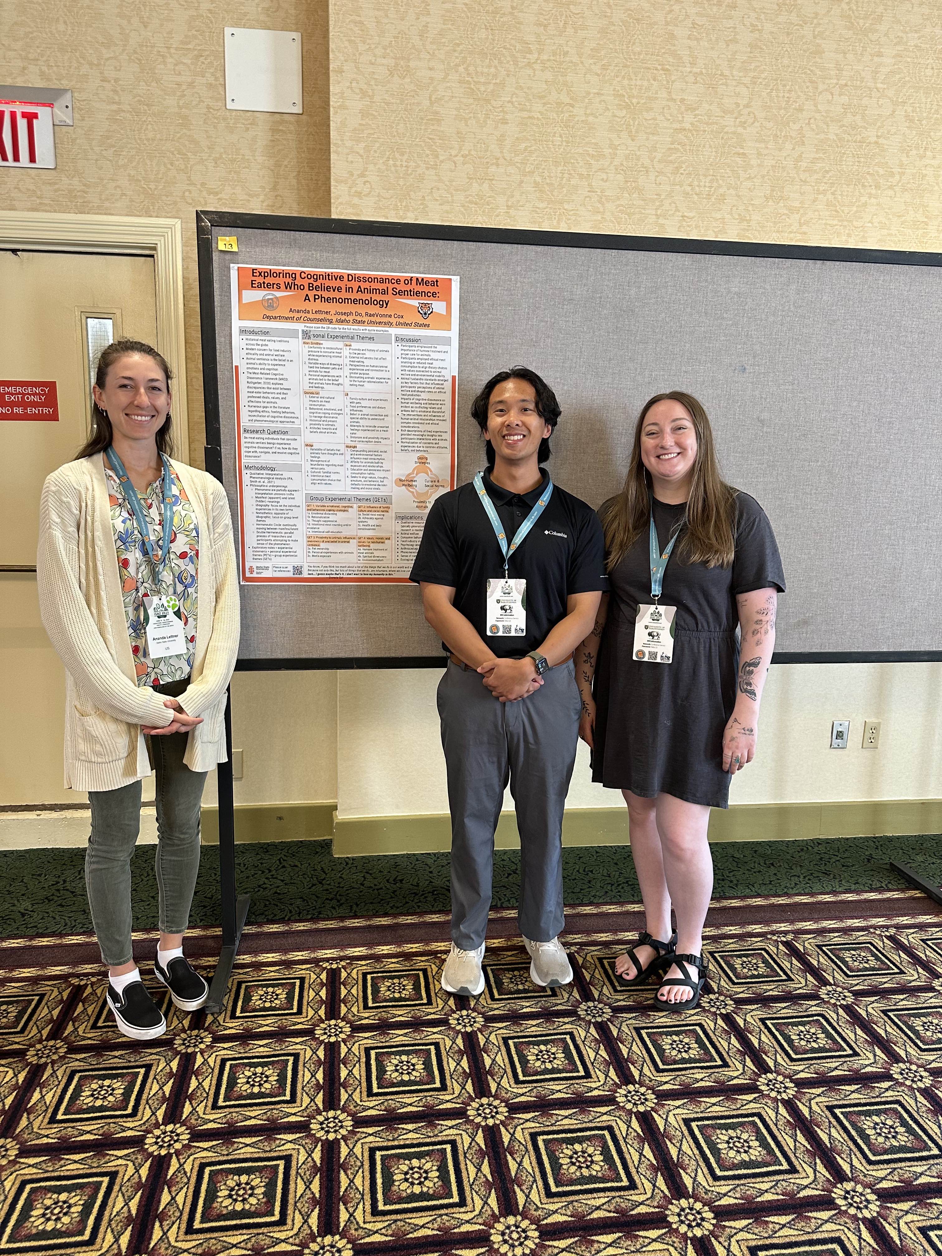 Raevonne Cox posing with fellow classmates as they present their research poster