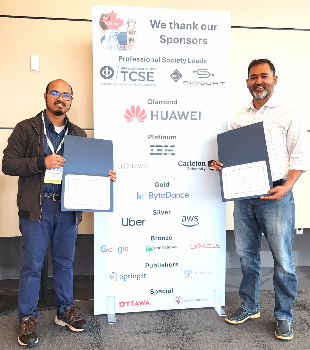 Md Fazle Rabbi and Dr. Minhaz Zibran posing with their awards