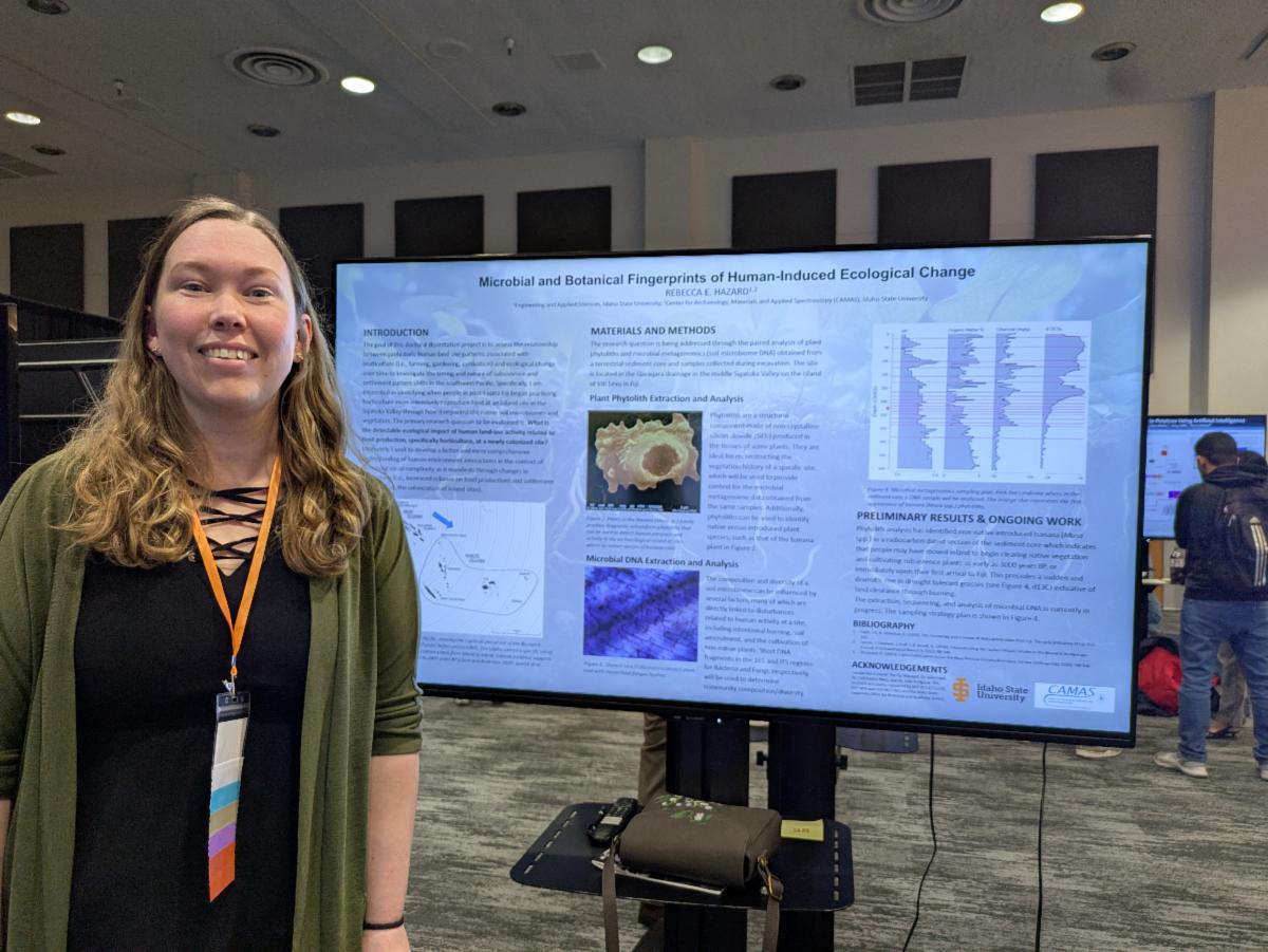 Rebecca Hazard posing in front of her research poster