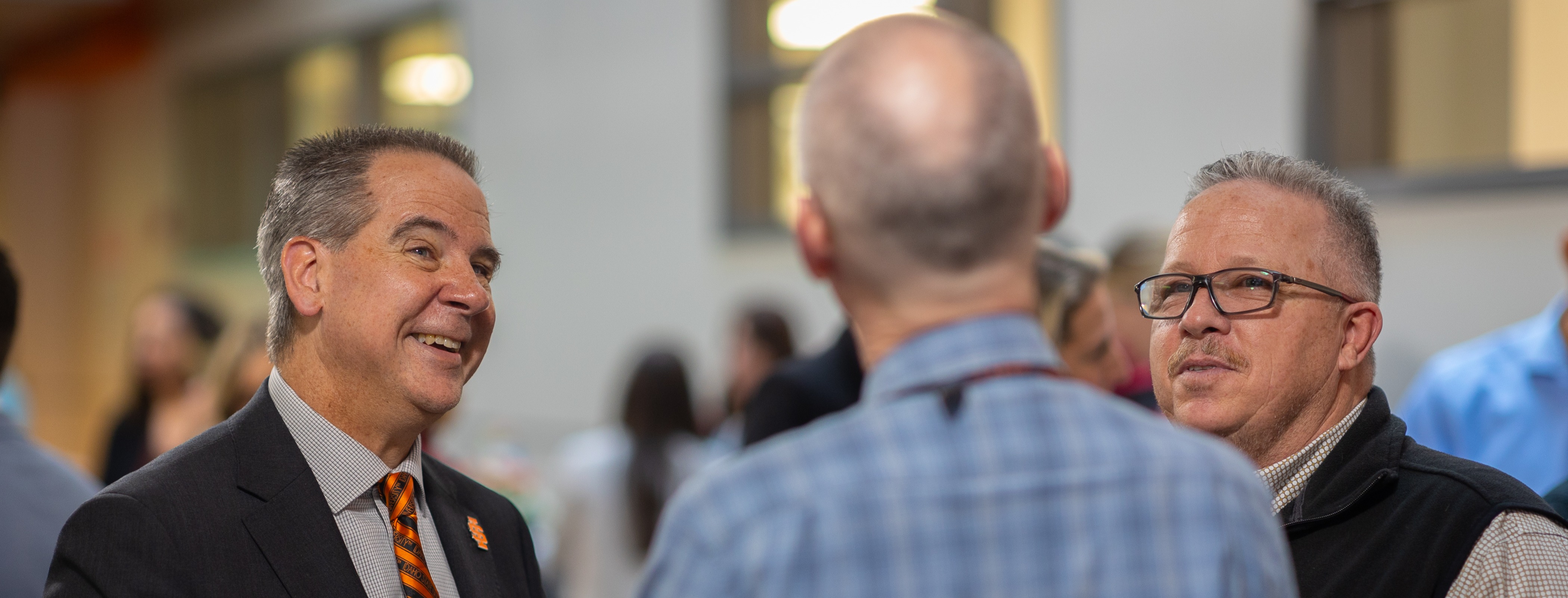 President of ISU, Dr. Robert Wagner conversing with faculty