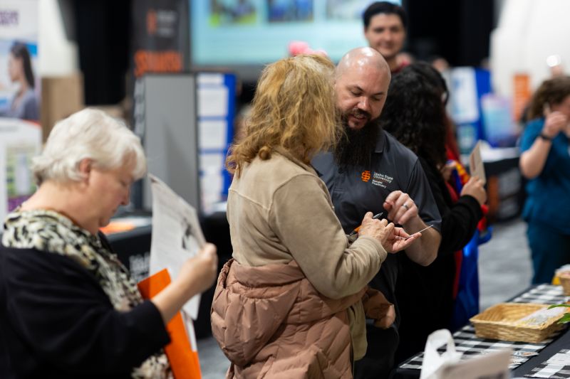 Bengal Pharmacy booth talking to health fair attendees