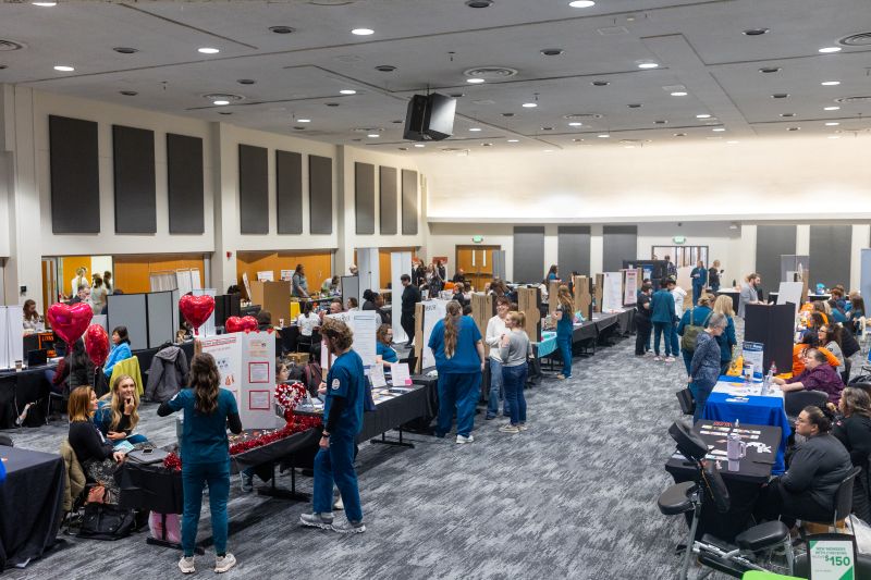 Health fair attendees visiting vendor booths
